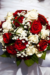 Bridal bouquet. The bride's . Beautiful of white flowers and greenery, decorated with silk ribbon, lies on vintage wooden chair
