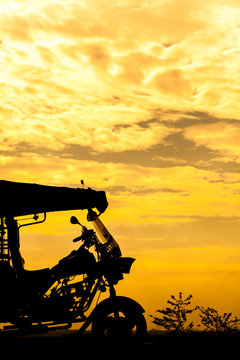 Silhouette of Tricycle in Thailand on sky sunset background
