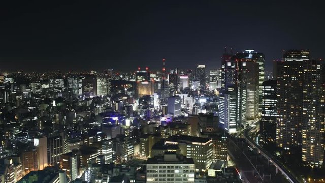 Time lapse Tokyo skyline at night. Traffic, lights, trains, skyscrapers.