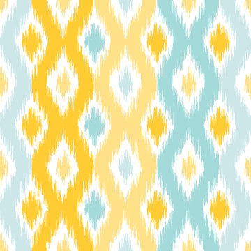 Seamless geometric pattern, based on ikat fabric style. Vector illustration. Carpet rug texture vector imitation. Yellow and turquoise mint ogee pattern.