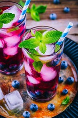 Blueberry ice sangria with mint in glasses