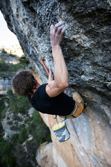 Rock climber ascending a challenging cliff. Extreme sport climbing. Freedom, risk, challenge, success. Sport and active