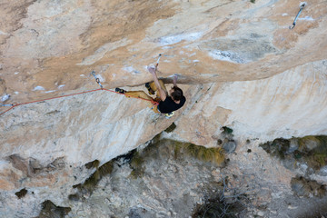 Extreme sport climbing. Rock climber struggle for success. Outdoor lifestyle. A person trying hard to reach sucsess.