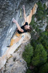 Rock climber ascending a challenging cliff. Extreme sport climbing. Freedom, risk, challenge, success. Sport and active