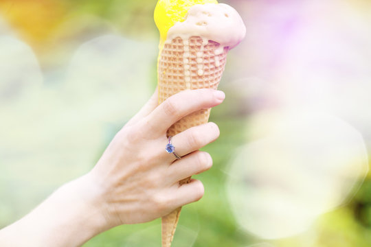 Tasty ice cream in beautiful female hand