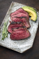 Japanese Kobe Steak Fillet with Avocado as close-up on a plate