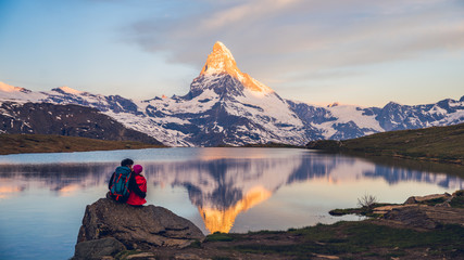 Romantic couple at sunrise, from lake Stellisee, Swiss Alps , Matterhorn Peak, Zermatt, 2017 - obrazy, fototapety, plakaty