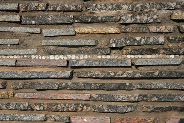 Detail of a wall of thin granite slabs. Texture, background