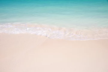 Poster Sand and caribbean sea background, tropical beach travel concept © Delphotostock