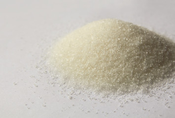 Heap of granulated rafinated sugar. refined sugar sand background.