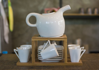 Pot with cup in coffee shop