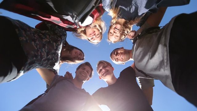 Smiling group of teenage friends in circle