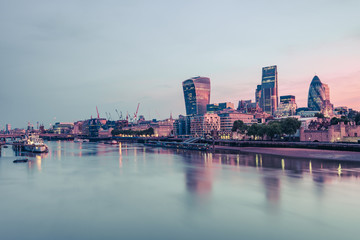 Fototapeta na wymiar Skyscrapers in London reflection in Thames river