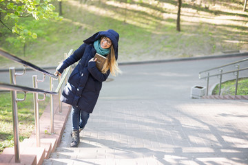 Happy girl is standing by the railing.