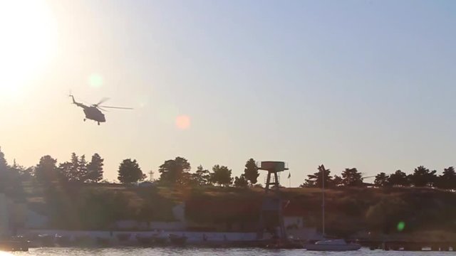 hd video of silhouettes of military helicopters  is taking off at sunset