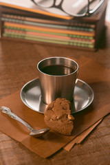 coffee Cup with spoon and biscuits on the background of notebooks