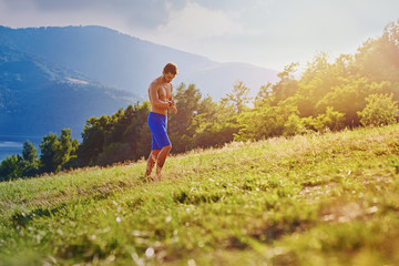 Trial runner setting his activity tracker, watch