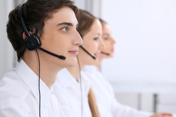 Call center. Focus on a man in headset