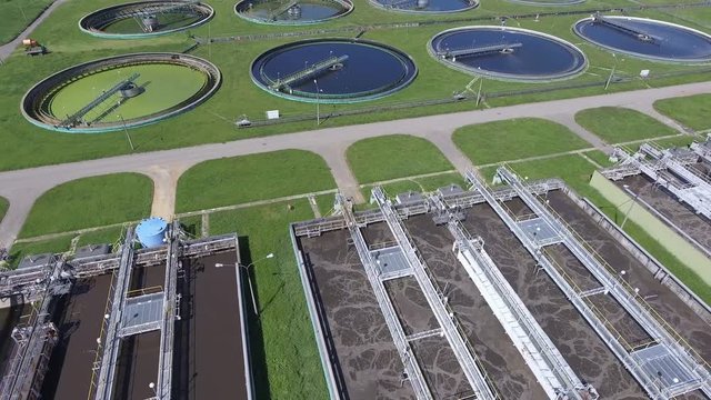 Sewage farm. Static aerial photo looking down onto the clarifying tanks and green grass.