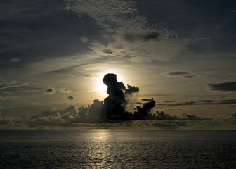Sun setting through thunder storm in Aldabra