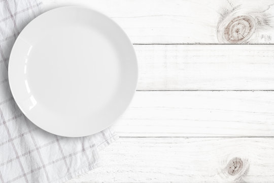 Top View Of Empty Food Plate Put On Tablecloth And Wood Table., All White Object With Copy Space.