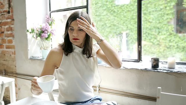 Elegant woman hurry while drinking coffee in the cafe, steadycam shot
