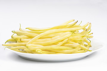 Yellow kidney beanson a white plateisolated on white background