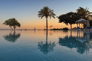 Fototapeta na wymiar Tropical swimming pool at sunrise