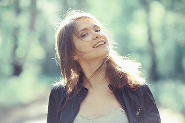 Young adult girl on a walk in the park jacket clothes