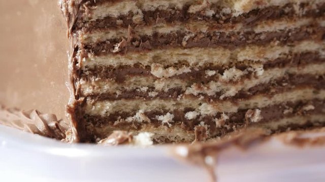 Creamy chocolate cake on the plate slow tilt 4K 2160p 30fps UltraHD footage - Tilting on layers of tasty torte with biscuits 3840X2160 UHD video