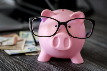 Pink piggy bank with glasses