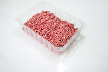 Package with fresh minced meat over a white background