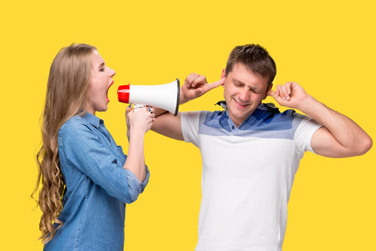 Woman shouting in megaphones at each other