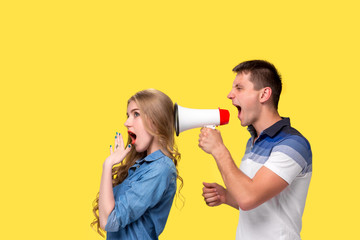 Man shouting in megaphones at each other
