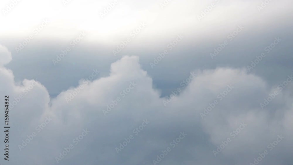 Wall mural clouds while flight.view through an airplane window.
