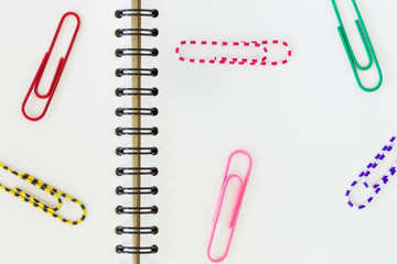 paper clips on blank notebook