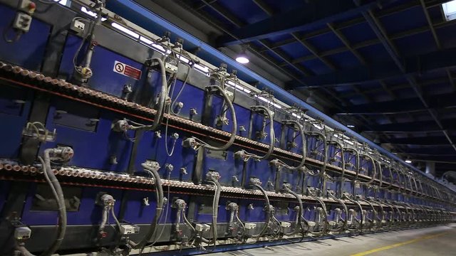 Tunnel kiln for baking ceramic tiles. Production of ceramic tiles. Automated production of ceramic tiles and porcelain tiles. Ceramic tile and porcelain tile production plant from the inside.