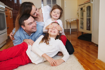 Fototapeta na wymiar happy family at home on the floor