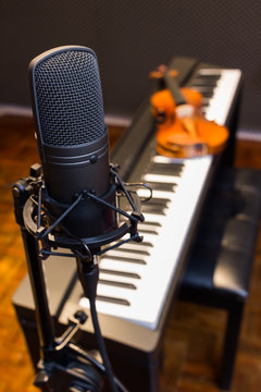 condenser microphone on piano & violin background