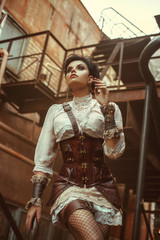 Portrait of a girl in a steampunk style. She is dressed in cool, unusual clothes. Creative colors