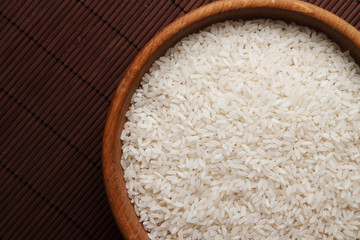 Raw rice in wooden bowl