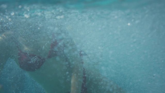 Medium time lapse tracking shot of friends jumping into pool. Cedar Hills, Utah, United States