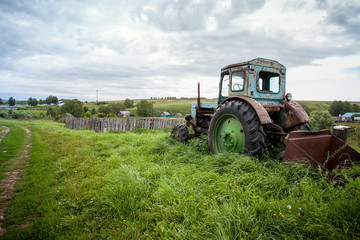 Old village cozy background with agricultural machine with copy space