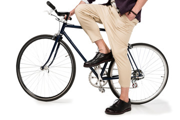 Fototapeta na wymiar Cropped shot of stylish young man sitting on bicycle isolated on white