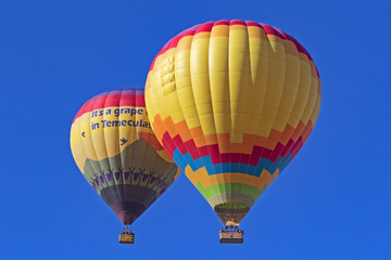 Balloons fly over California grape vineyard and winery during Hot Air Balloon Festival