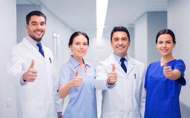 medics or doctors at hospital showing thumbs up