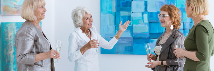 Women discussing painting