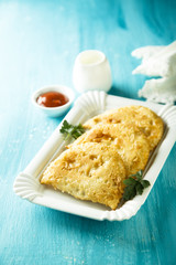 Fried meat pies with tomato sauce