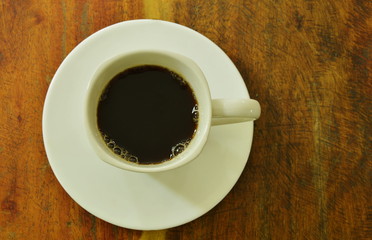 black hot coffee in cup on dish 