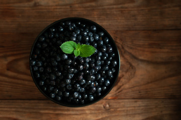 blueberries in round ceramic bowl on wooden table